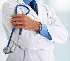 doctor in white coat holding a stethoscope