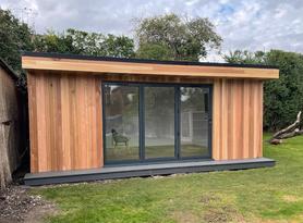 Modern cedar clad garden room with 3 panel bifold doors in Billericay, Essex built by Robertson Garden Rooms