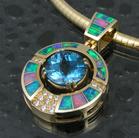 Australian opal pendant with blue topaz in 14k gold.