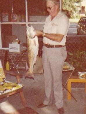 Thomas Eddie Waters holding a red fish