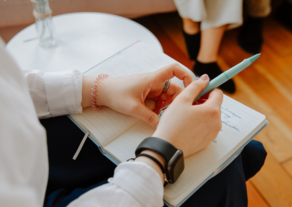 Counselor taking notes in therapy session