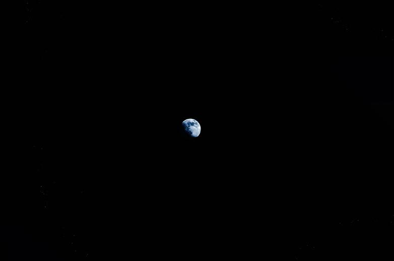 blue moon in dark sky night photo