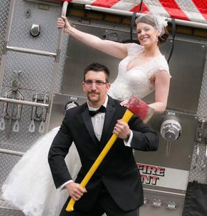Fun Newlywed pose for a fireman and bride on their wedding day in Minnesota