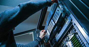 Man setting up server equipment.