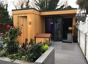 Modern cedar clad garden room with storage, split face feature wall and LED lighting in Romford, Essex built by Robertson Garden Rooms