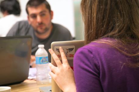 female and male interaction showing laptop screen startup