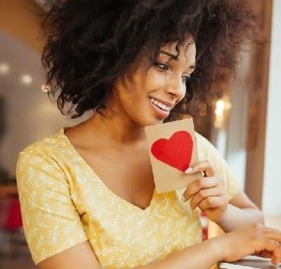 This woman is smiling because she used this love spell and got her crush to contact her and ask her out for a date.