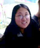 Head-shot of Rachel, smiling, looking at camera.