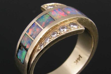 Diamond and opal inlay ring that needs repairs.