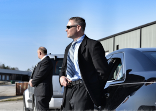 Two plainclothes agents protecting a client