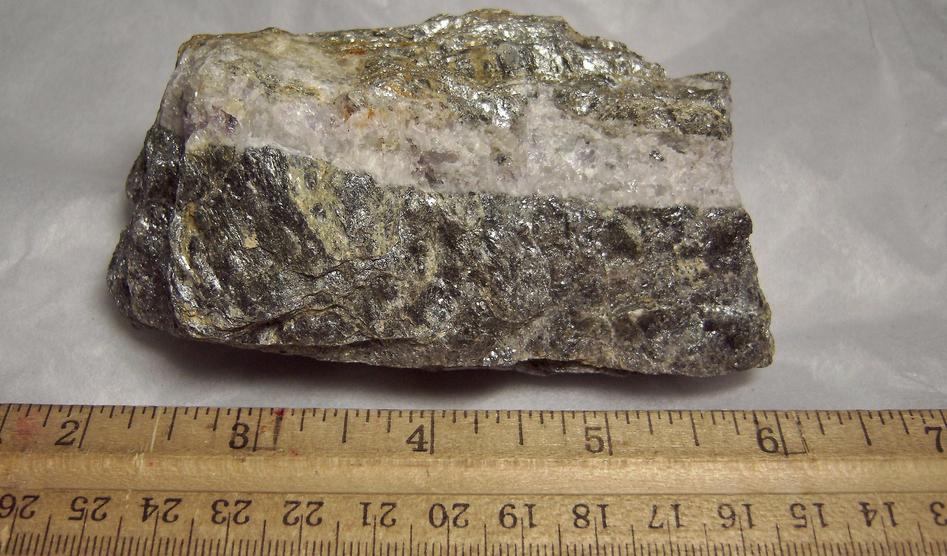 fluorescing FLUORITE, CALCITE, PYRITE with MUSCOVITE - Thomaston Dam railroad cut, Thomaston, Litchfield County, Connecticut, USA