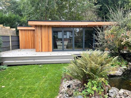 Modern cedar clad garden room with 5 panel bifold doors