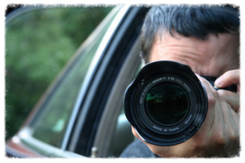 A Private Investigator taking photos from his vehicle