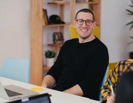 Man smiling at desk