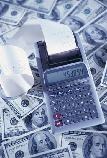 Picture of cash and calculator representing the value Zautcke CPA delivers with Controller & Accounting Services including Financial Reporting & Accounting, Cost & Management Accounting, Internal Controls and Compliance and Risk Management, and Tax Accounting & Compliance