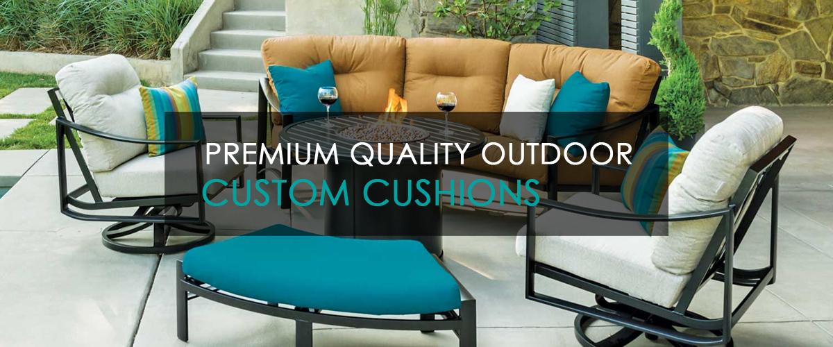 wrought iron curved outdoor sectional with grey, blue and rust colored snbrella replacement cushions. 