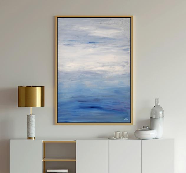 Blue Art ocean seascape in light blue and white which shows calm ocean water and clouds in the sky.