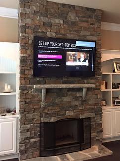 flat screen 4k ultra flat screen tv mounted on stacked stone fireplace in charlotte nc, we mount tvs on fireplaces in charlotte nc