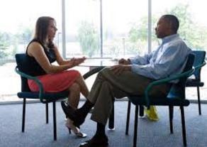 Man and woman having discussion at an office table