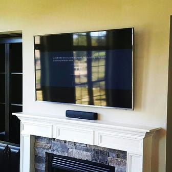 Flat screen tv over fireplace installatiion service in charlotte, flat screen mounted over fireplace with mounted speaker
