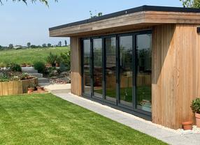 Modern cedar clad garden room with bifold doors and large feature window in Leigh-on-Sea, Essex built by Robertson Garden Rooms