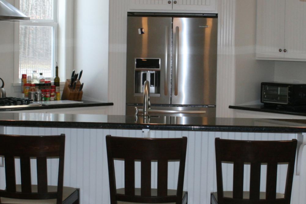 White Cabinets with a Gray Kitchen Island - Homecrest