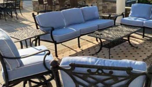 wrought iron outdoor furniture with sky blue cushions with white cording