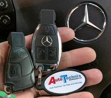 Mercedes Chrome remote key next to a 2 button original Mercedes key
