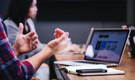 Image of two people in a business meeting with a laptop