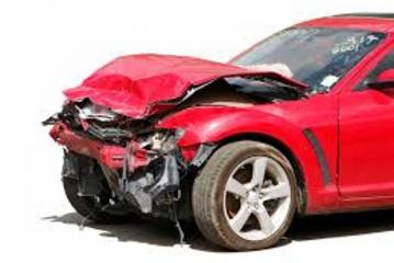 a red car that was totaled in an fatal accident on the highway.