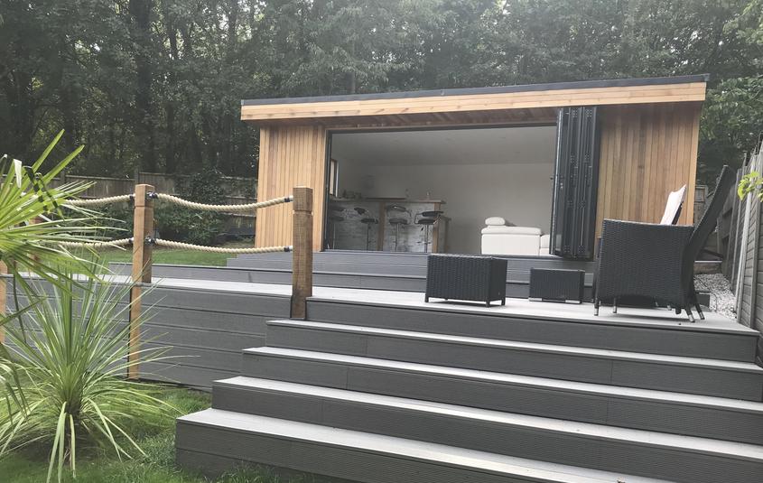 Modern cedar clad garden room with bifold doors and large deck, in Langdon Hills, Essex built by Robertson Garden Rooms