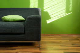 Green wall with couch.