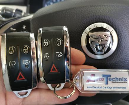 Jaguar remote keys in front of a Jaguar steering wheel emblem
