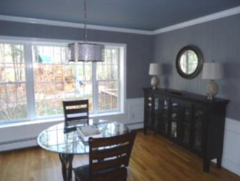 Dining room with gray accent ceiling.