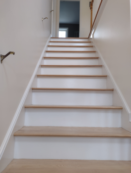 After priming and painting stairway, risers and skirtboards white semi-gloss.