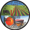 Circular logo for the city of Webster with pastures, a cow, an orange, and a building.