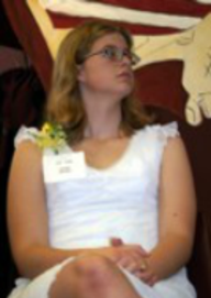 Ashley, sitting on chair at 2004 STF reception with legs and arms crossed,, looking to her left.