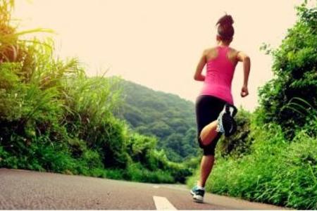 Photo of woman running on street