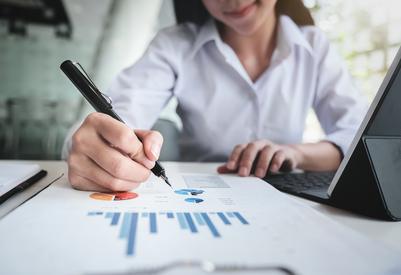 Lady holding a pen and report
