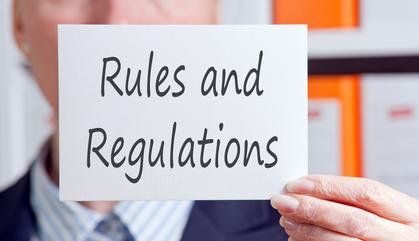 Business lady holding a Rules and Regulations sign