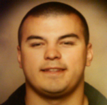 Head-shot of Marcus smiling at camera.