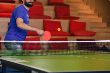 ping pong match with red sofa background