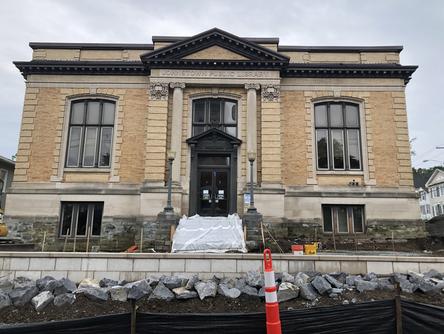 Front shot of library building with retaining wall and boulder wall.