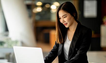 One person at an office working with a laptop