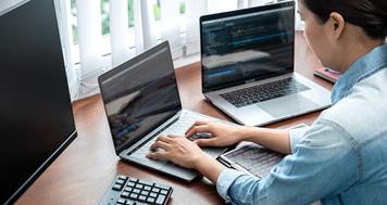 Woman employee working on a laptop.