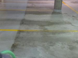Clean It Right, professional pressure washing midway through cleaning this parking garage.