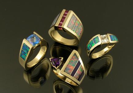 Australian opal rings with a variety of colored gemstone accents set in 14k gold.