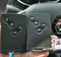 2 Renault key cards next to each other in front of a Renault steering wheel with an Autotechnix key ring attached to 1 of the key cards