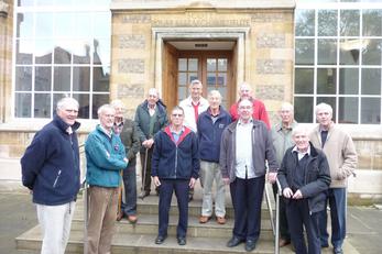 Men gathered on steps outside house