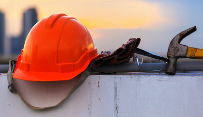 Construction safety hat, glasses, gloves and hammer